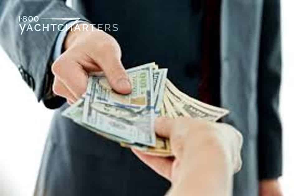 Tip picture. Photograph of businessmen hands exchanging money.  At the top of the stack of money is a 100 dollar bill.