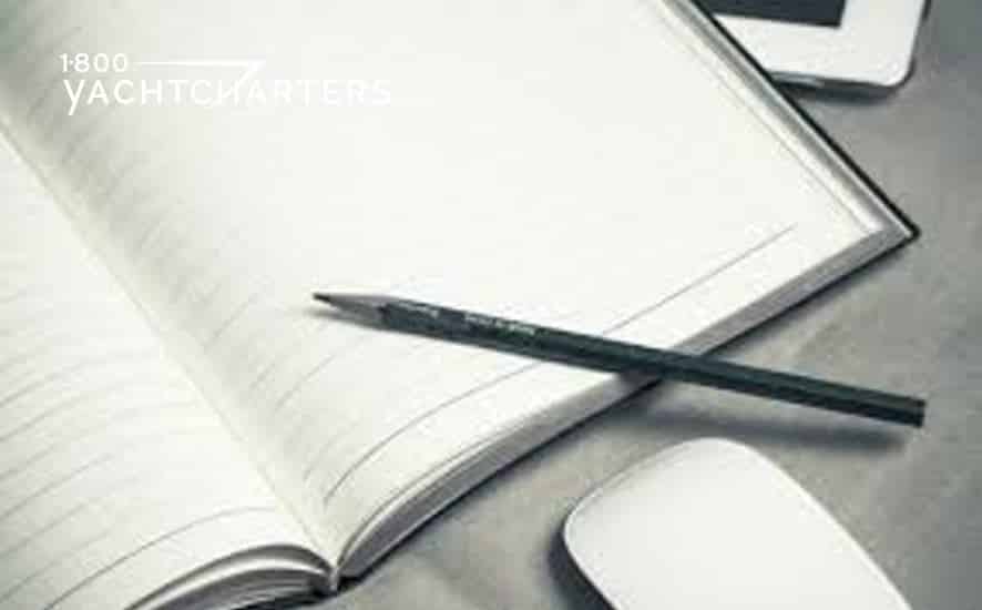 planner. Black and white photograph of a pencil on an open notebook. There's a computer mouse in front of the notebook