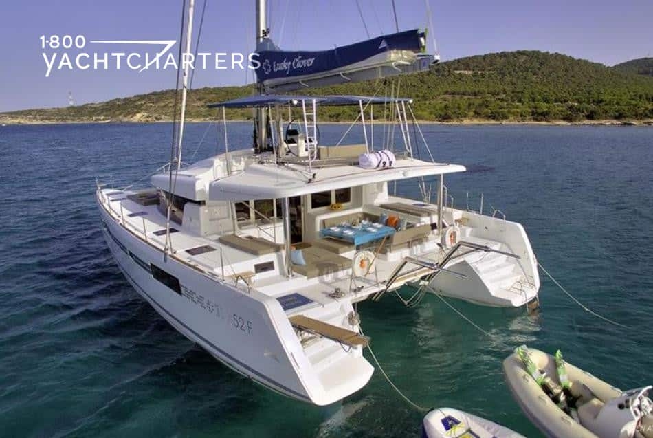 Photograph of a catamaran sailoat at anchor. Photo taken from back left side of boat. Photo taken in Greece.
