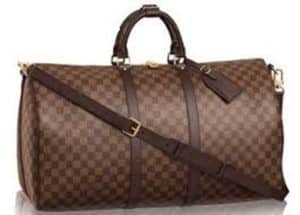 Photograph of a brown Louis Vuitton travel duffle bag with a white background.