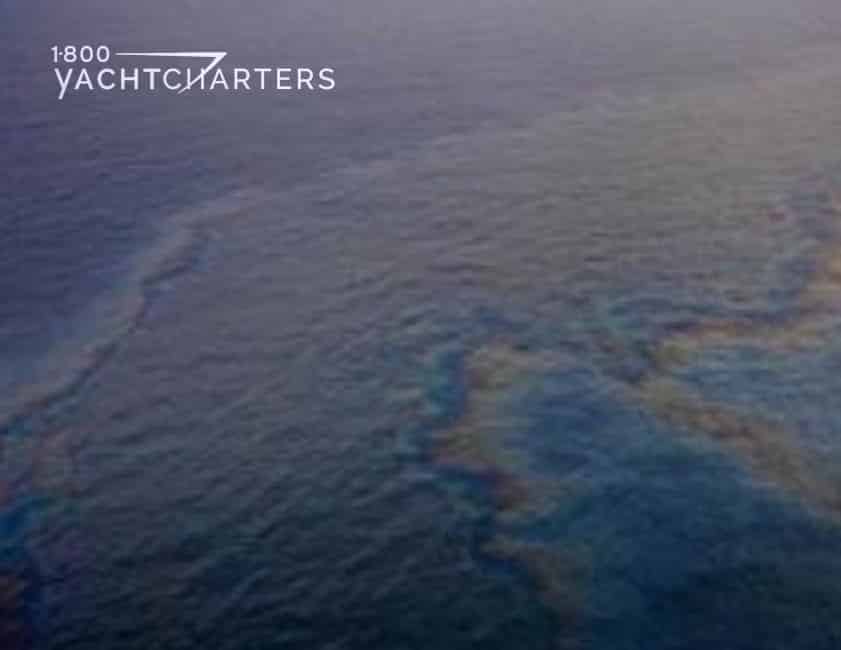 Photograph of oil slick over calm water