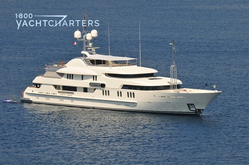 Profile of a solid white motoryacht. She is facing the right side of the photograph