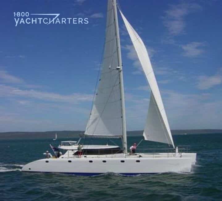 Executive catamaran photograph.  Picture is profile with yacht facing to the right. 