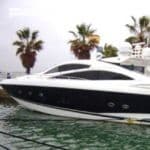 At dock - white powerboat with thick black horizontal stripe across side
