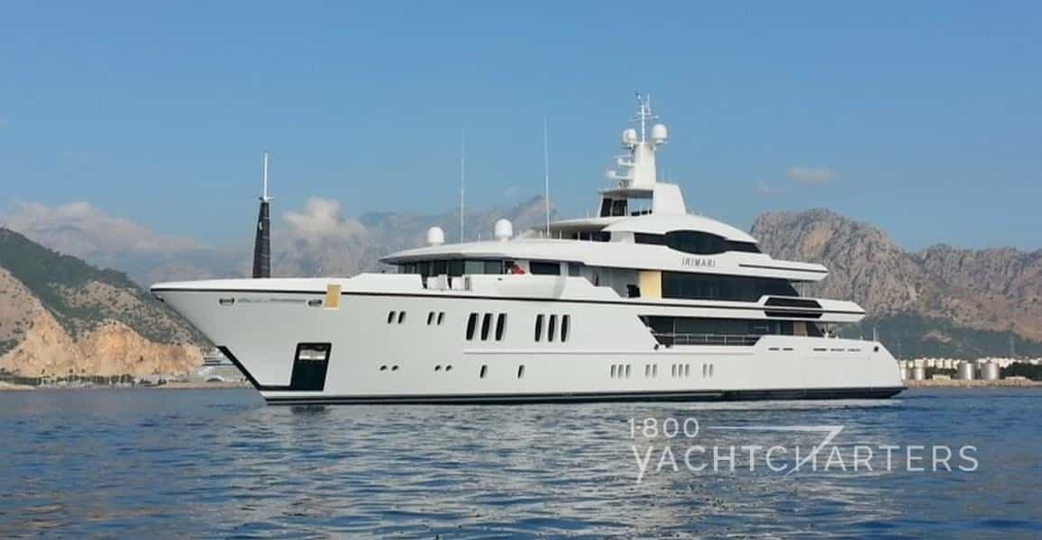 superyacht Irimari side profile solid white boat at anchor on calm sea