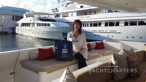Jana Sheeder sitting on the aft couch of a yacht in a marina