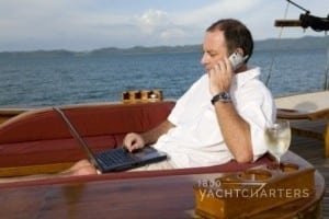 man on wooden boat talking on cellphone