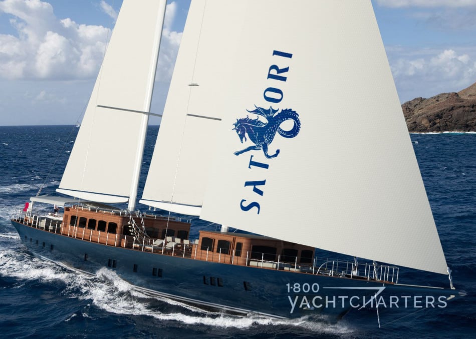 Schooner Satori sailboat underway with large turquoise seahorse on white sail